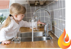 child at a kitchen water tap